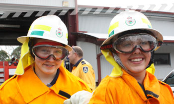 Two young female volunteers wearing Personal Protective Clothing (PPC)