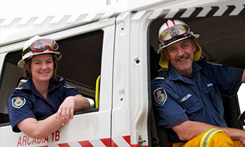 Brigade members sitting a NSW RFS fire truck