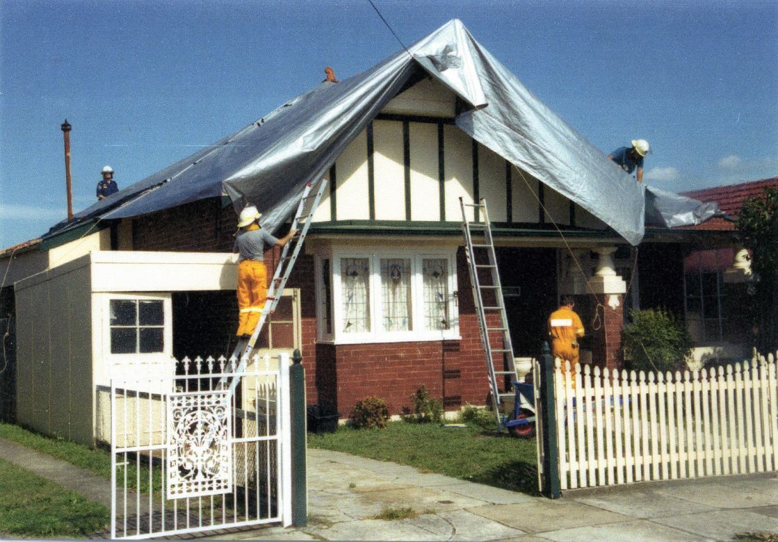 Tarpaulins cover the roofs of houses damaged during the Sydney Storms, 1999