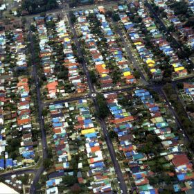 Sydney Storms, 1999 Coloured tarpaulin cover the roofs of houses damaged during the Sydney Storms, 1999