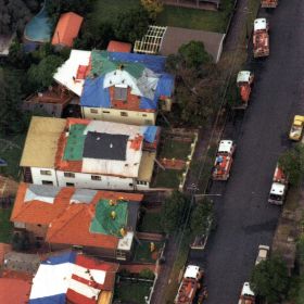 Sydney Storms, 1999 Coloured tarpaulin cover the roofs of houses damaged during the Sydney Storms, 1999